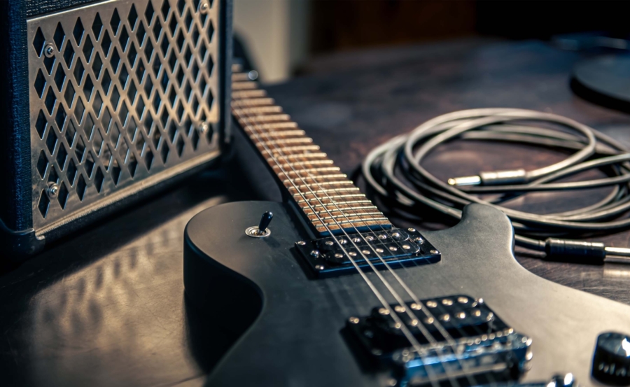 closeup-black-electric-guitar-dark-background.mijpg