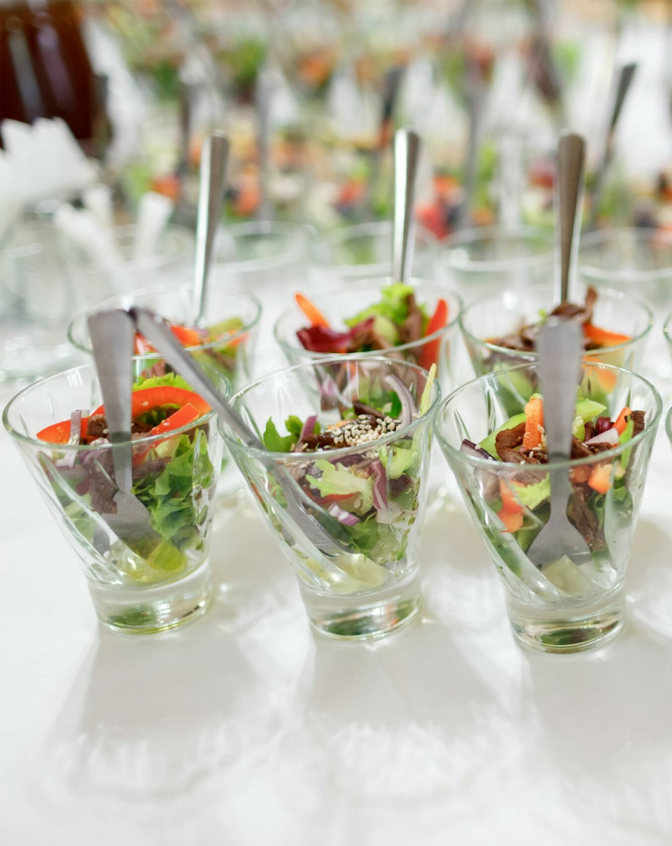 glasses-with-salad-served-white-tablfde-min
